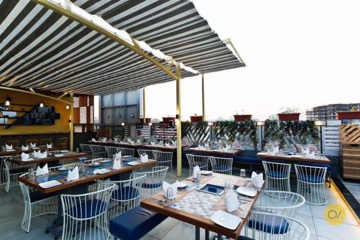 open restaurant space with metallic cushioned chairs and wooden table