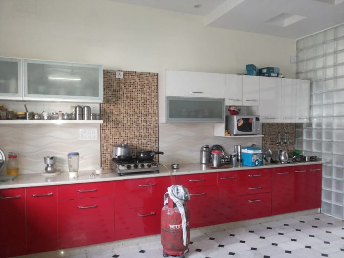 Red And White Themed Modular Kitchen With Microwave By Anjali Raghav
