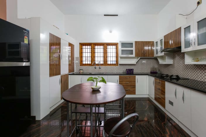 L Shaped Modular Kitchen with White and Brown Cabinets and Marble Flooring by Monnaie Architects