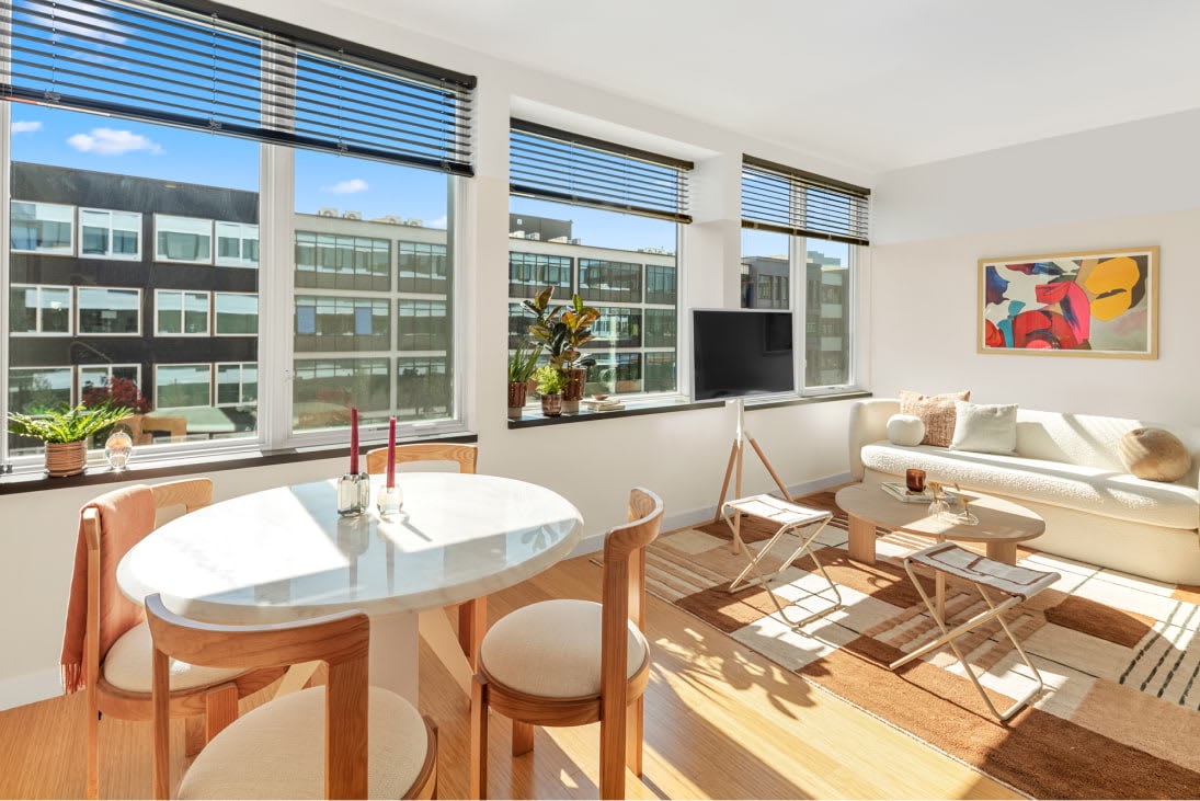 View of the designer living room and oversized windows at Harrison Urby - luxury Harrison NJ apartments for rent
