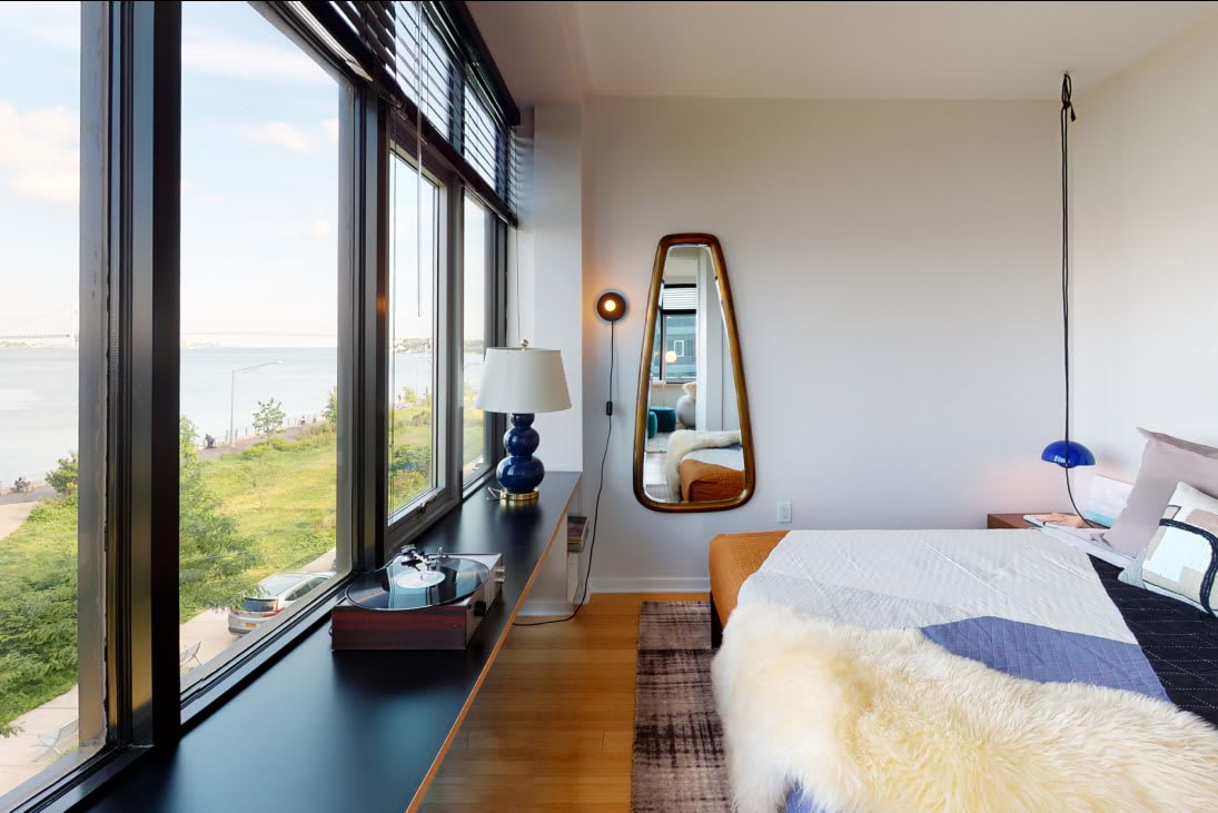 View of the designer bedroom with oversized windows at Staten Island Urby - luxury Staten Island apartments for rent