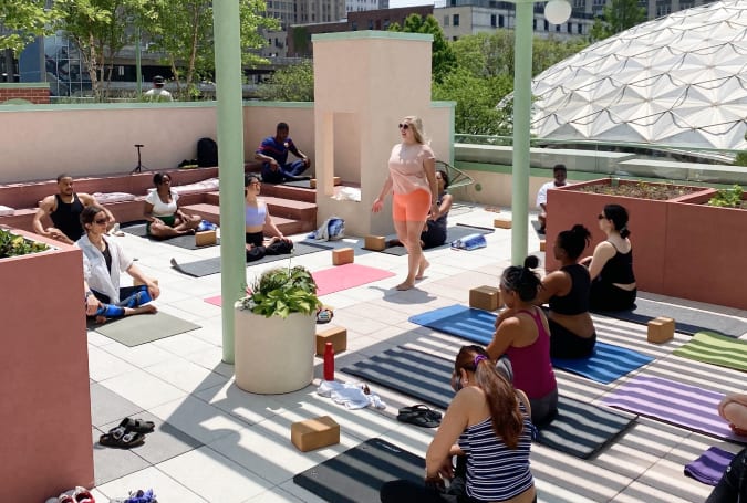 Outdoor resident yoga class on the roof deck.