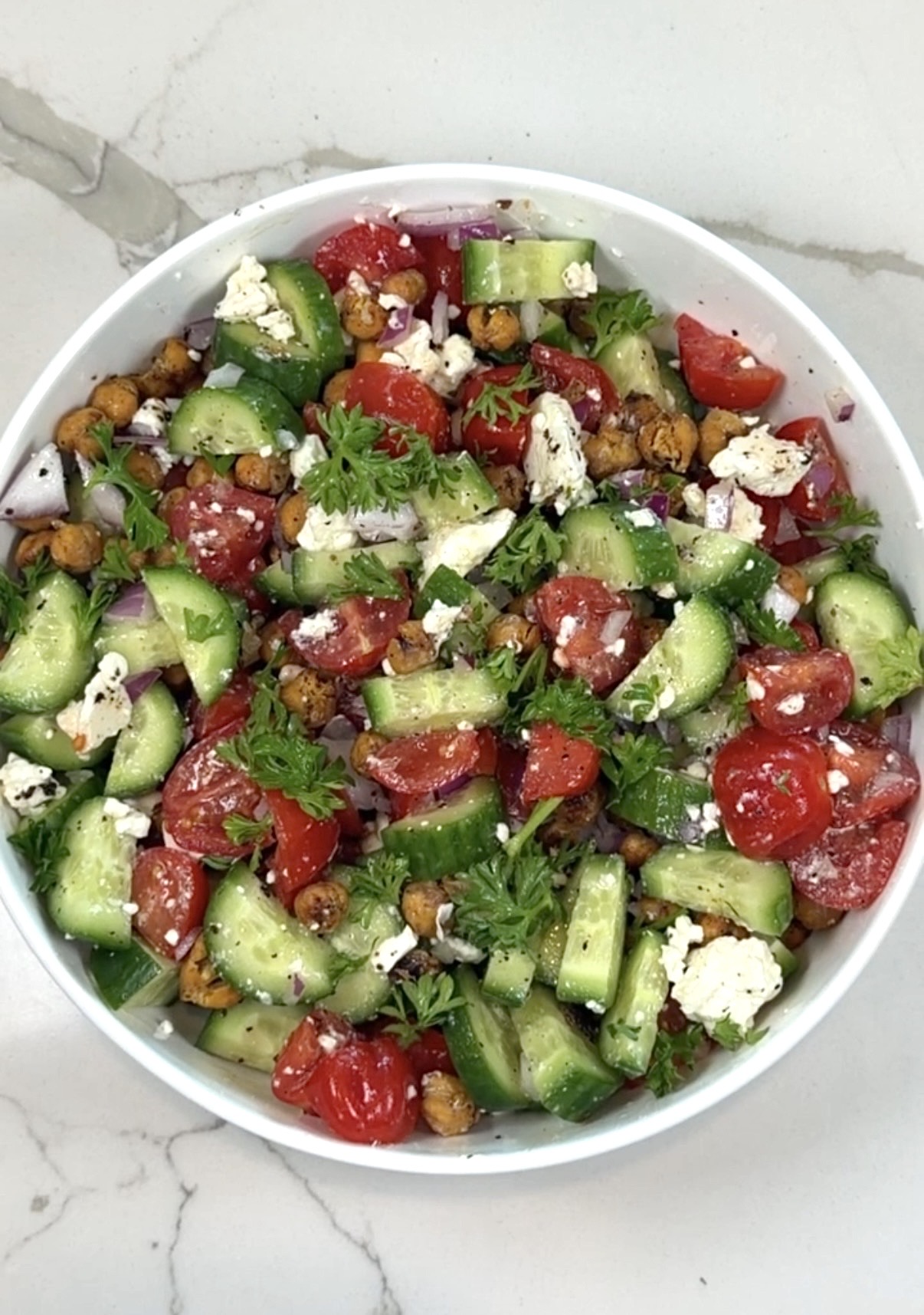 crispy chickpea salad with cucumber, cherry tomatoes, red onion, feta, and parsley