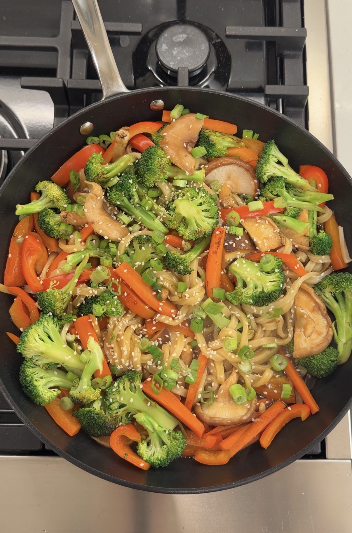 veggie udon stir-fry with shiitake mushrooms, broccoli, carrots, and red bell pepper