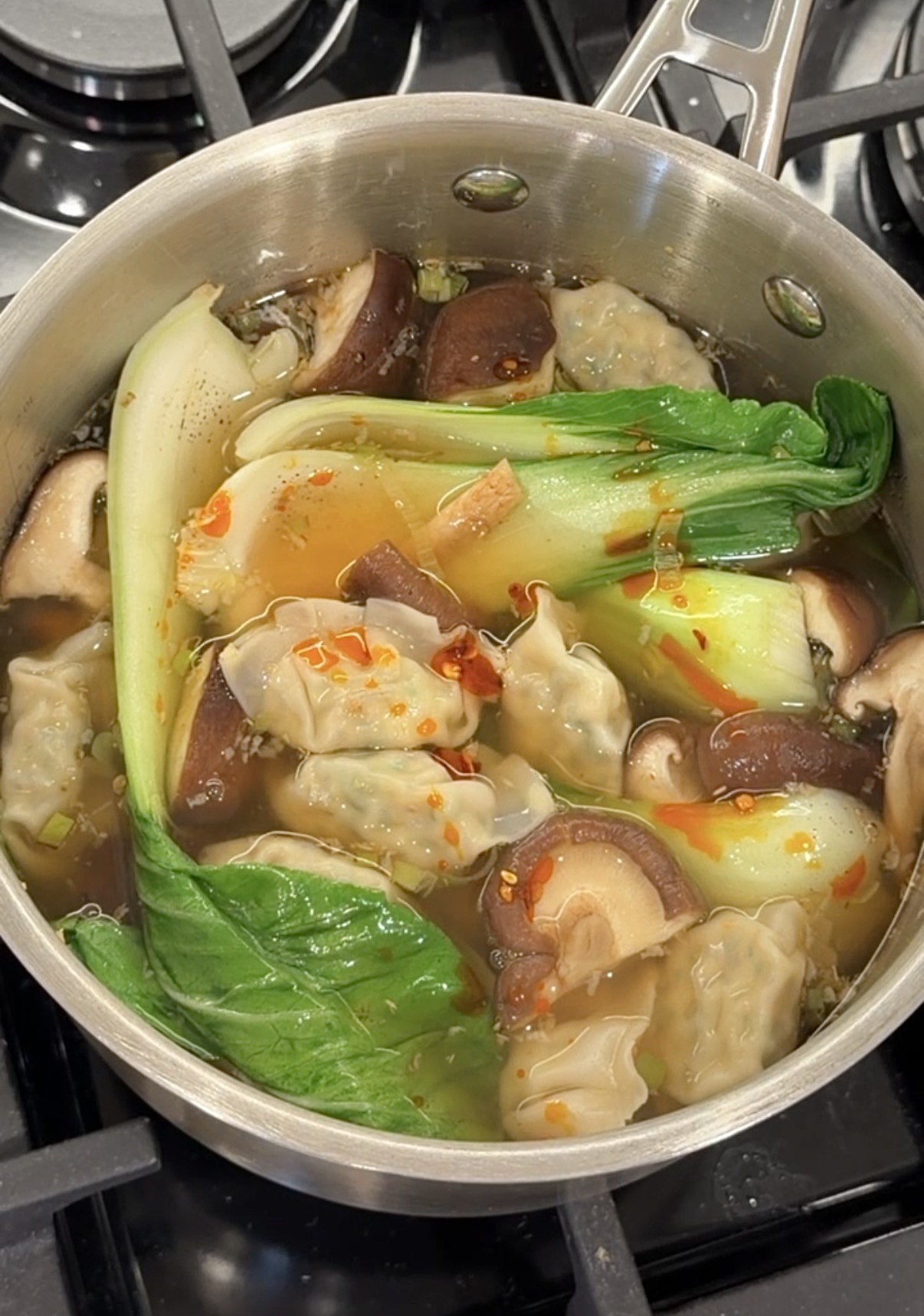 vegetable wonton soup with shiitake mushrooms, bok choy, scallions, and chili oil