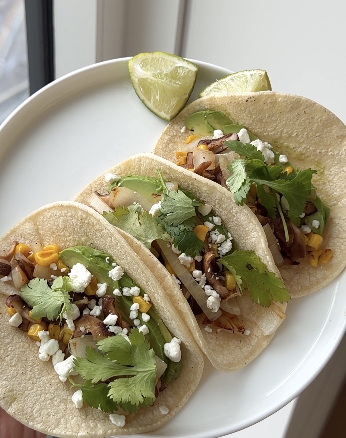 shiitake mushroom tacos with corn, avocado, goat cheese, cilantro, and lime