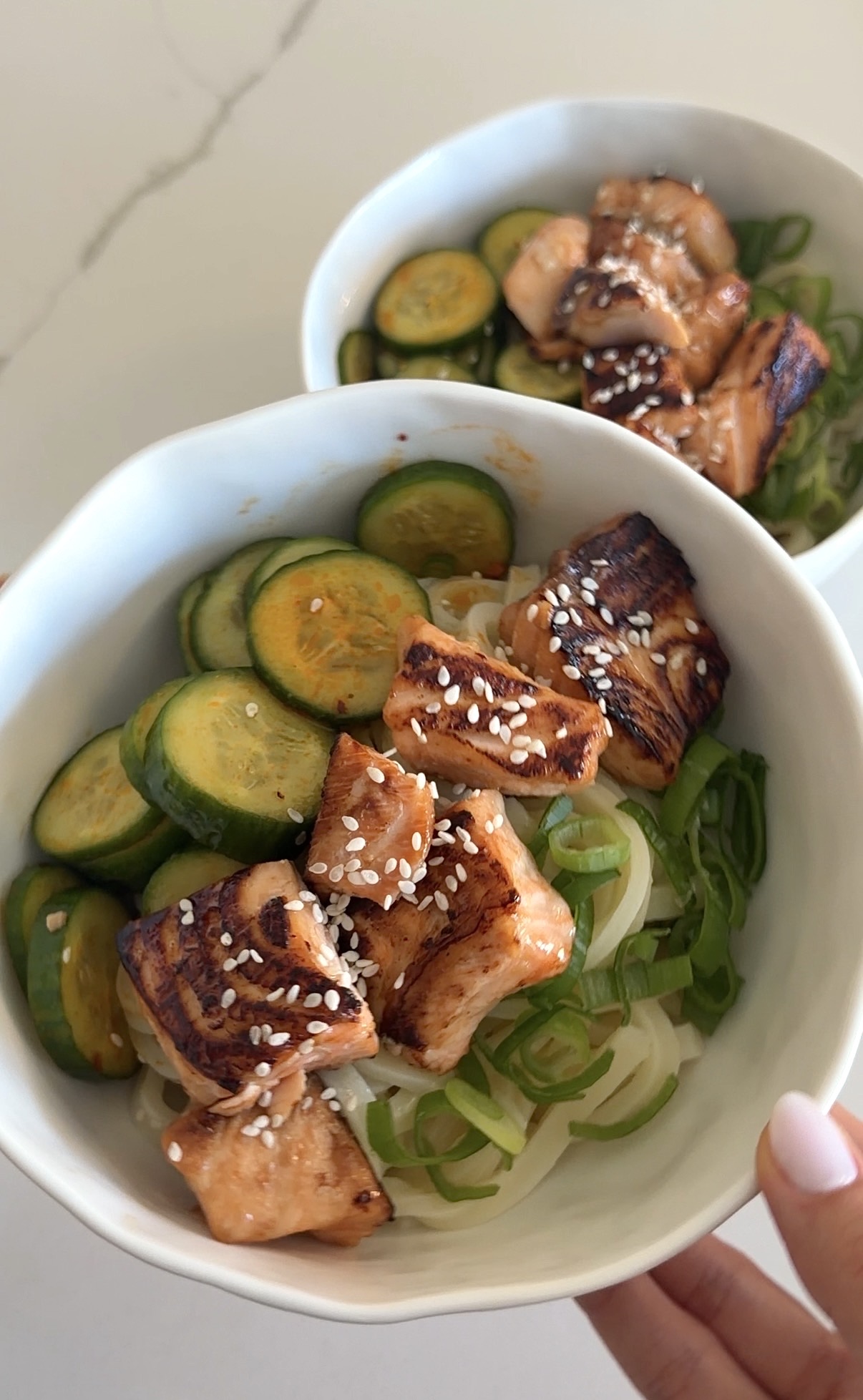 honey soy salmon served with udon noodles and spicy cucumber salad