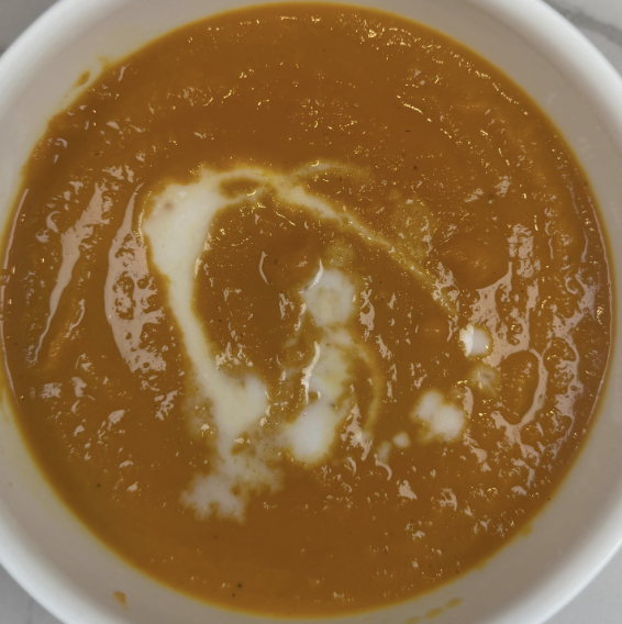 creamy carrot ginger soup with turmeric and a swirl of coconut milk