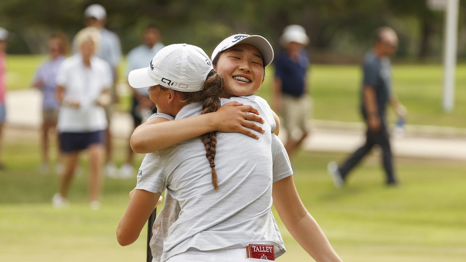 Northern Californians Sarah Lim (facing) and Asterisk Talley enjoy a championship moment on the 16th green of Oak Hills C.C. (USGA/Chris Keane)
