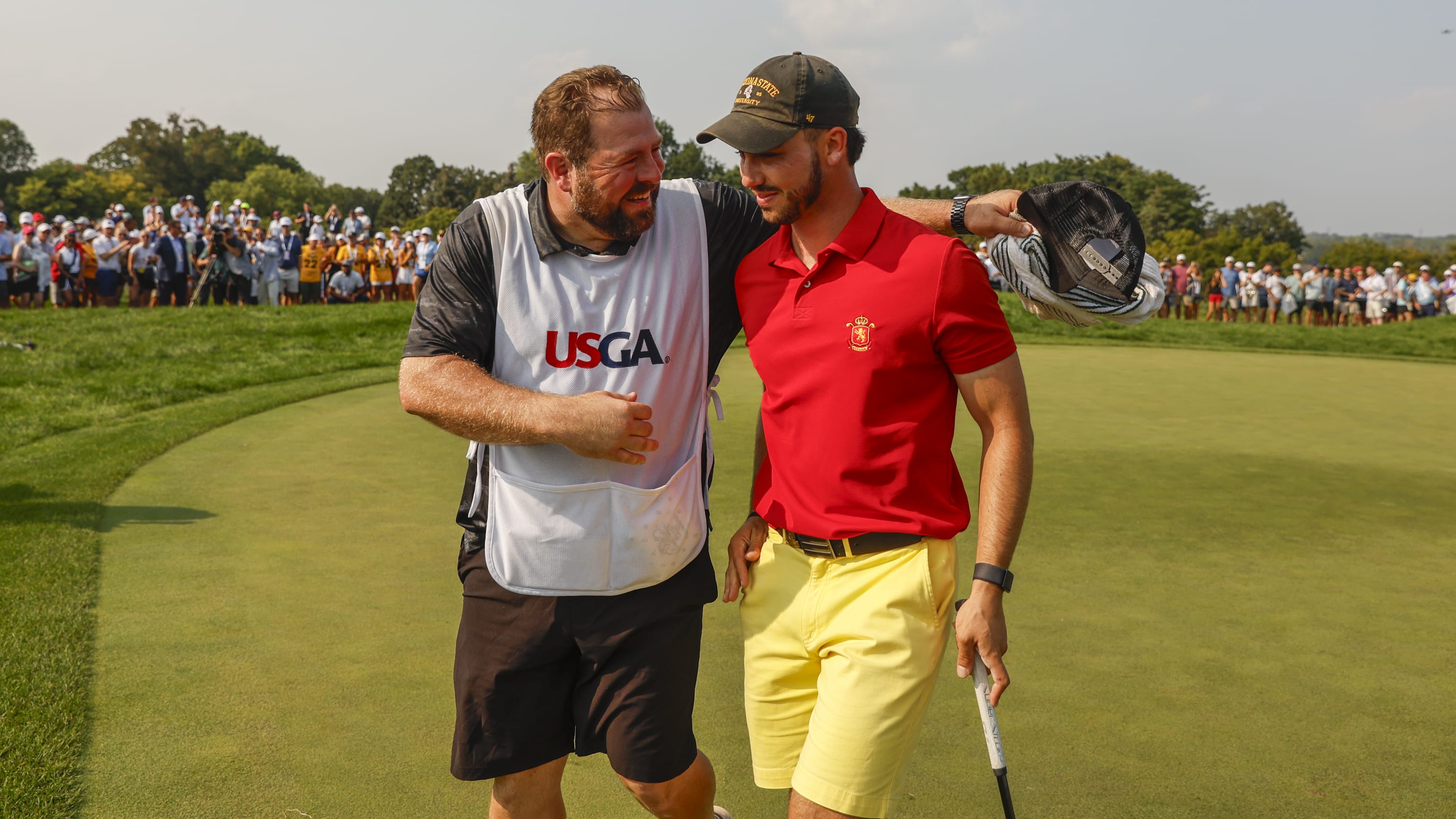 Jose Luis Ballester and his caddie, Alberto Ballester (no relation) enjoyed an emotional walk off the 36th green after Sunday's final. (USGA/Chris Keane)  