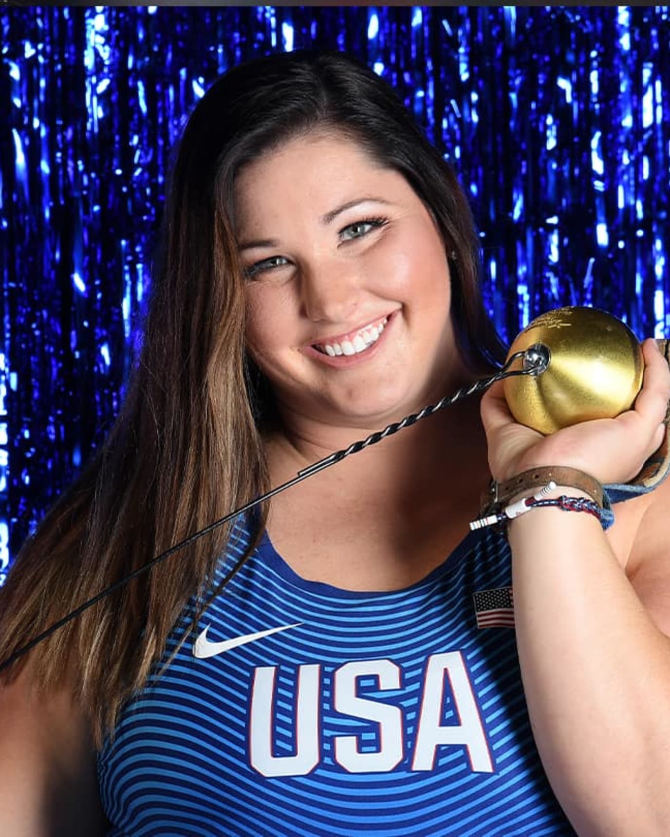 Deanna Price smiles and holds her hammer for a photo.