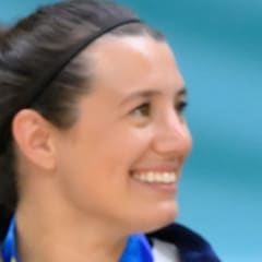 Emily Oberst smiling and holding a gold medal