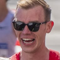 Clayton Young celebrates with fans after finishing second at the 2024 Olympic Marathon Team Trials in Orlando, Florida.