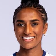 Naomi Girma holding a soccer ball and smiling