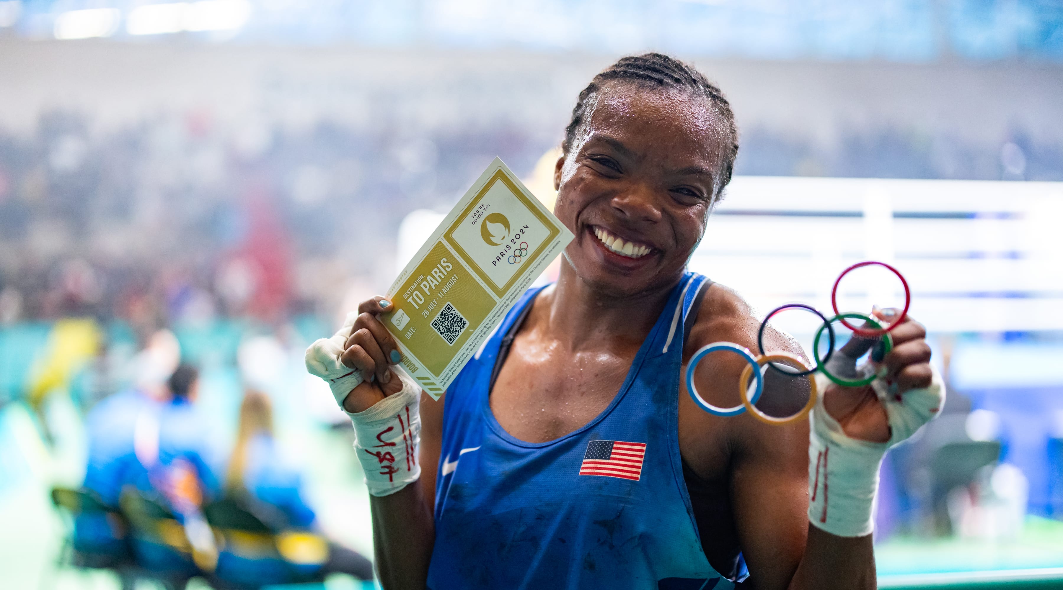 Morelle McCane of USA Boxing holds up her Olympic glasses and ticket to Paris 2024 after qualifying at the 2023 Pan American Games in Santiago, Chile.