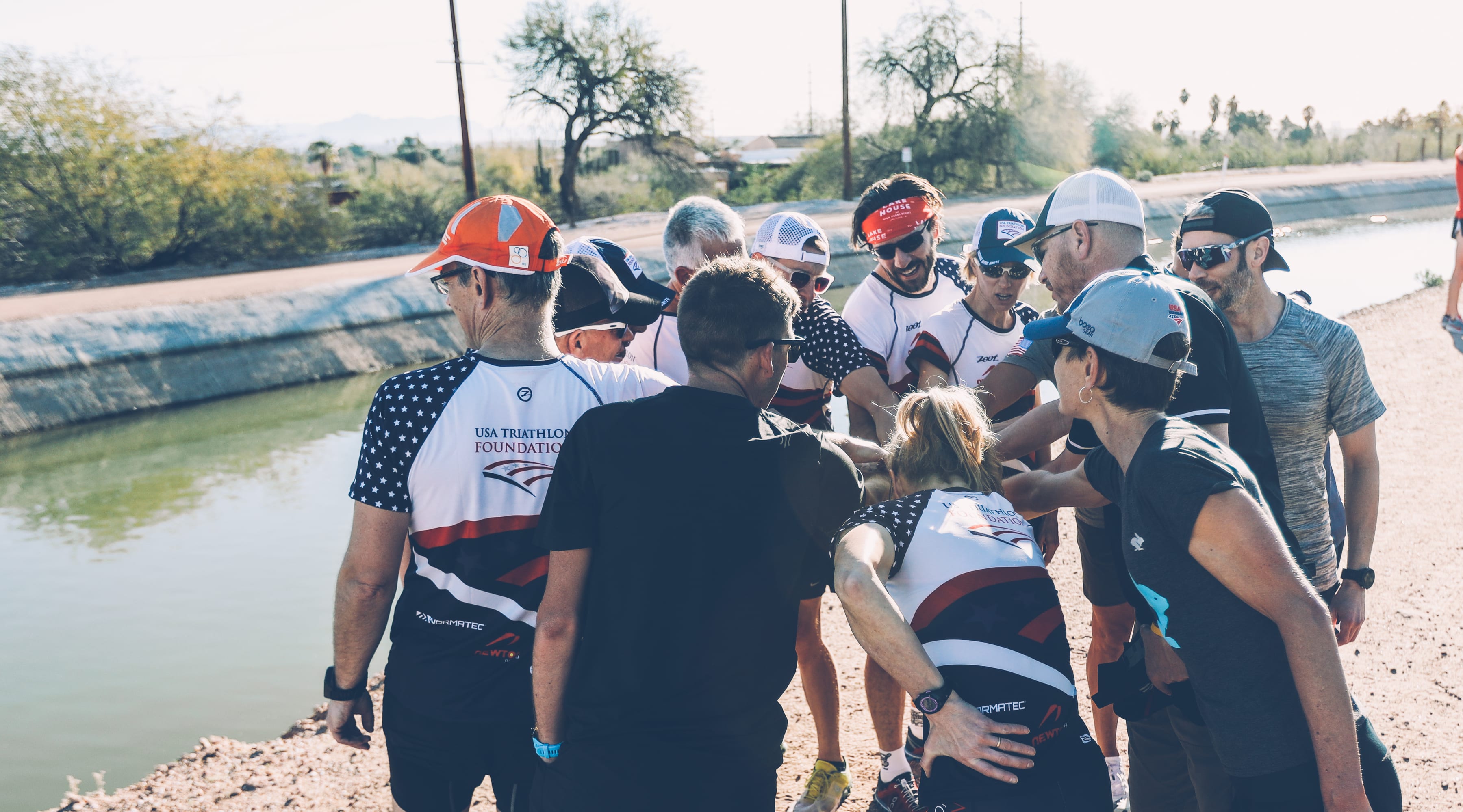 Participants in the USA Triathlon Foundation's Fantasy Camp huddle up for a team cheer.