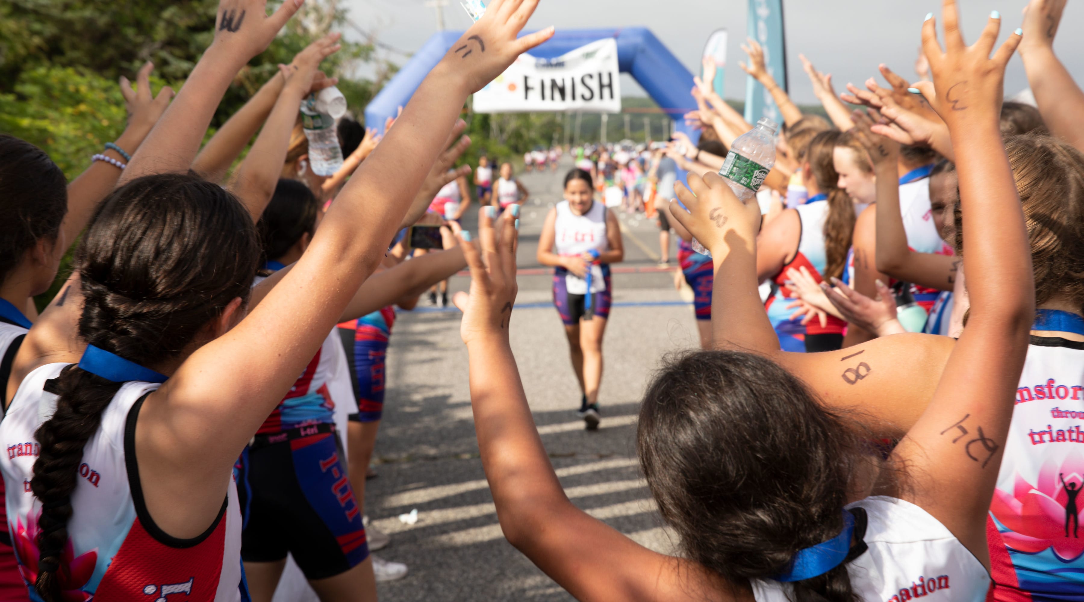 Members of i-tri welcome their teammates.