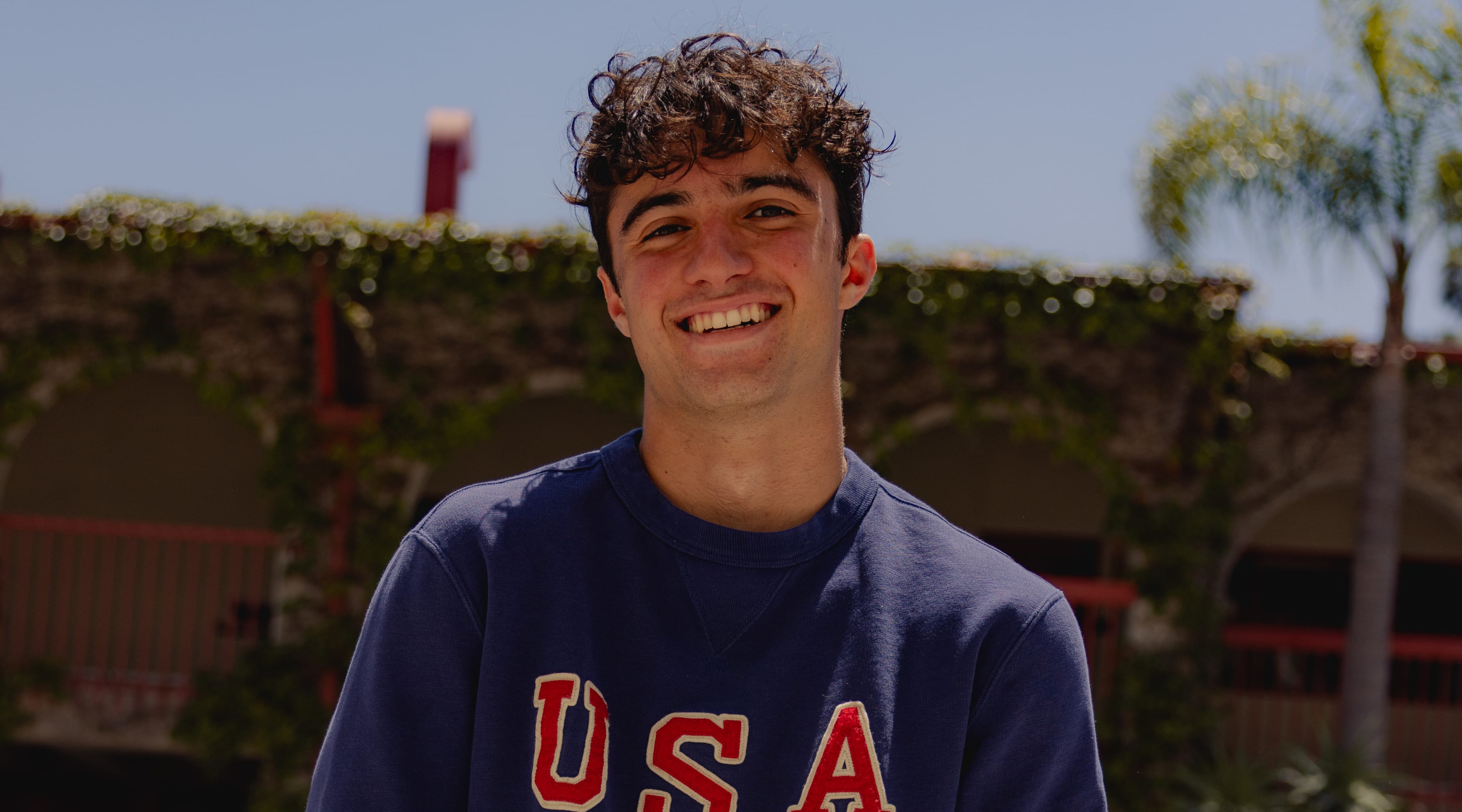 Ezra Frech smiles in a USA sweater