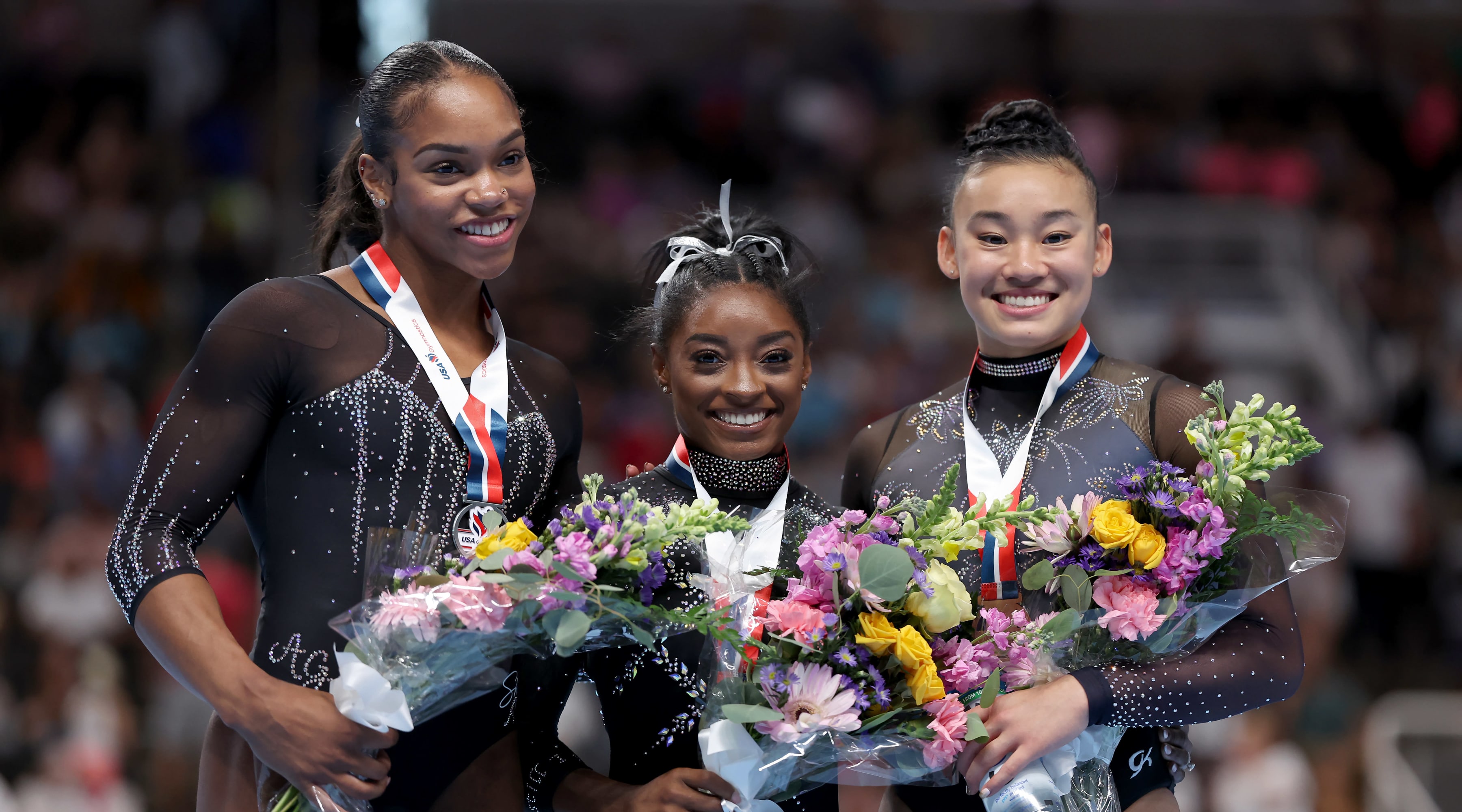 Shi Jones, Simone Biles, and Leanne Wong pose for photos after placing second, first, and third in the all-around competition on day four of the 2023 U.S. Gymnastics Championships at SAP Center on August 27, 2023 in San Jose, California.