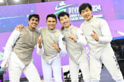 Four foil fencers celebrate