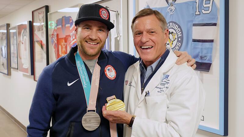 Mike Schultz reunites with Dr. Thomas Clanton, who performed heel surgery on the Paralympian in 2015