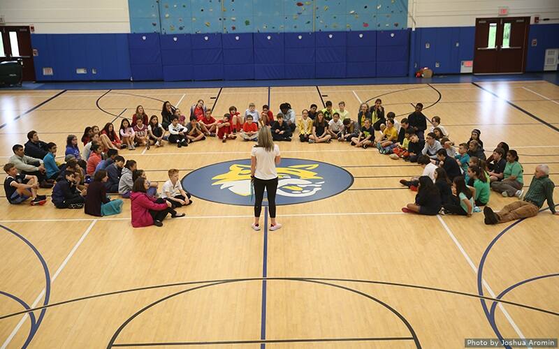 Kari Miller and Meghan Duggan visit with children at the Whitby School.