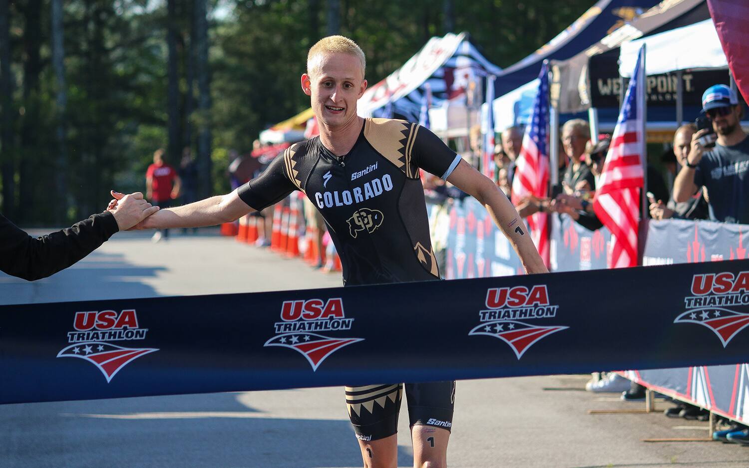 triathlete ben Bettin crosses the finish line