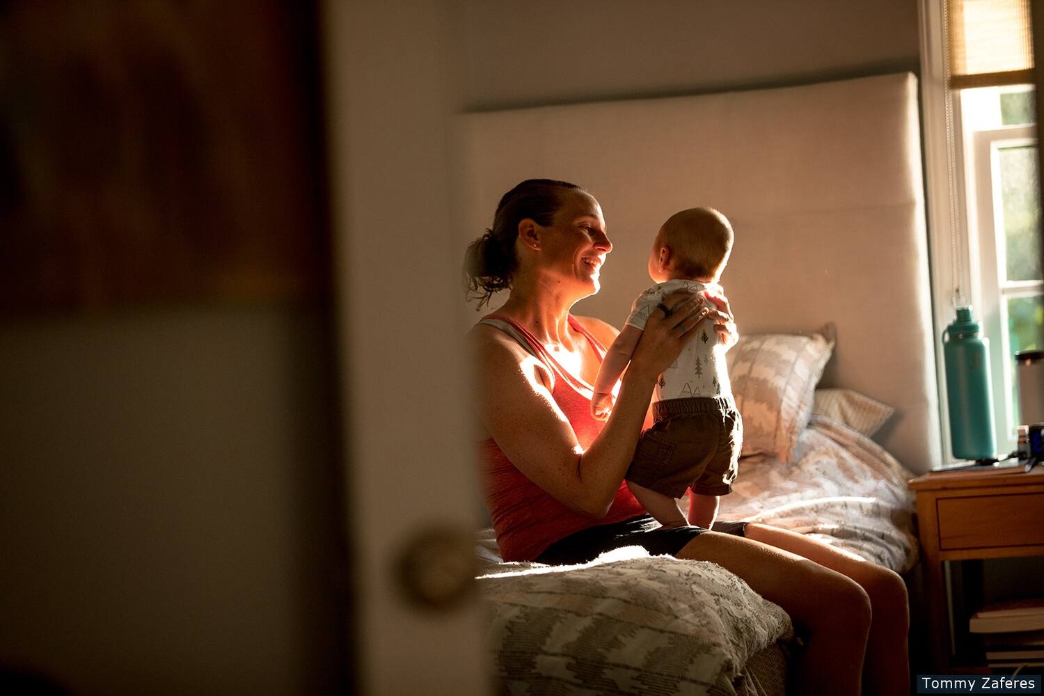 Katie Zaferes at home holding her son, Kimble