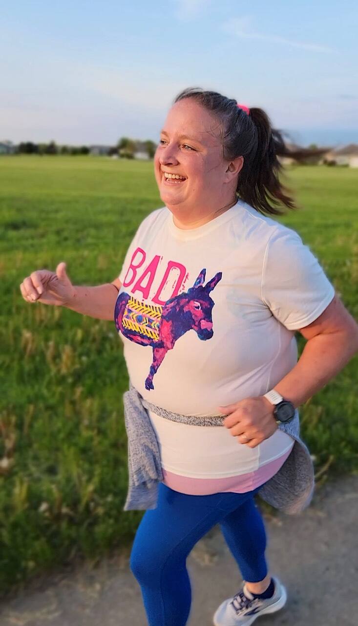 katie zornes running on a dirt path near grass