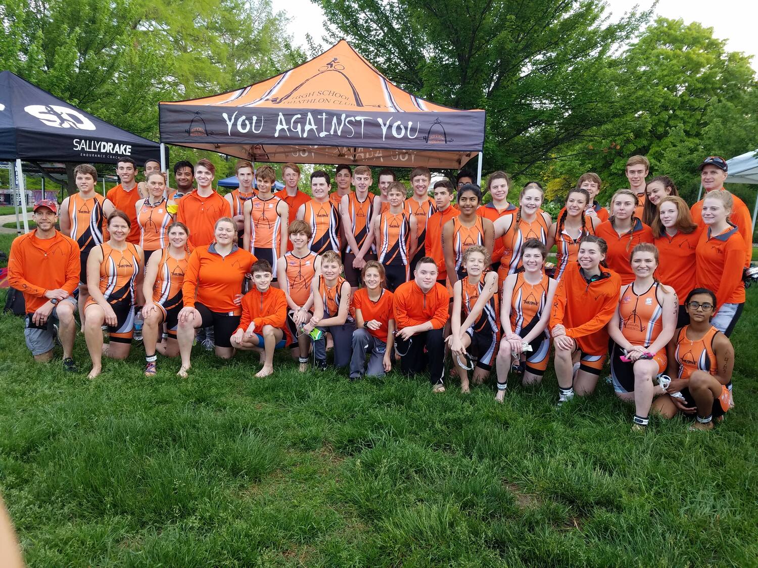 a large group of youth triathletes from the HSTri Club pose together