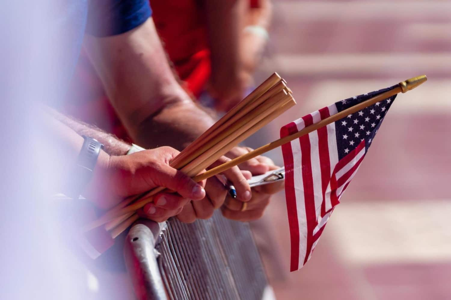 a person holds a small usa flag