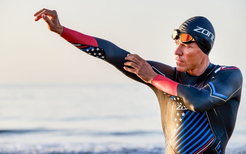 Athlete putting on wetsuit