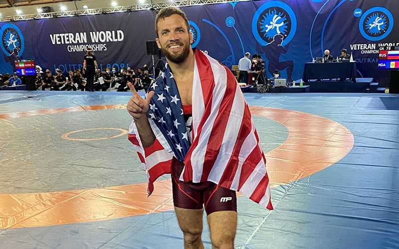 Reece Humphrey (USA) with the American flag flashes two fingers to recognize his Veterans double title