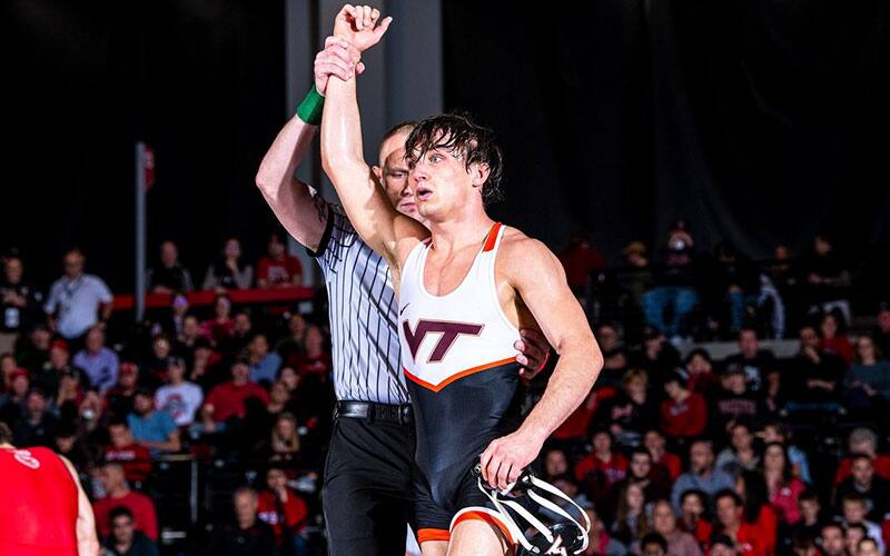 Caleb Henson (Virginia Tech) with arm raised in victory.