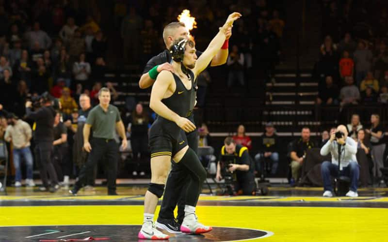 Spencer Lee (Iowa) has arm raised after win in Wisconsin dual.