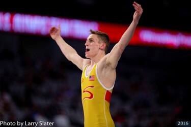 Benji Peak raises his arms in celebration after a win at U.S. Olympic Team Trials