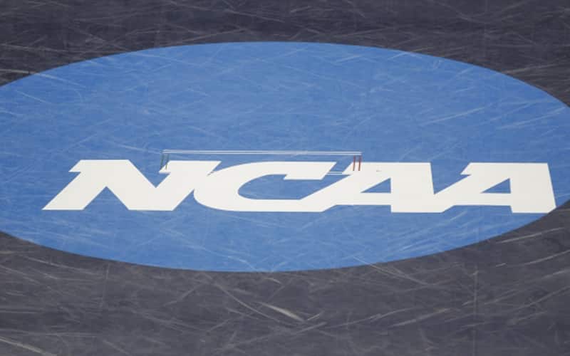 Wrestling mat with the NCAA logo on it