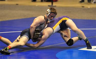 Two wrestlers in a takedown scramble at NCAA Div. II National Championships.