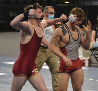 Josh Gerke of Coe pumps his fists in celebration after a semifinal win at the 2021 NWCA Div. III Coaches Association Nationals.