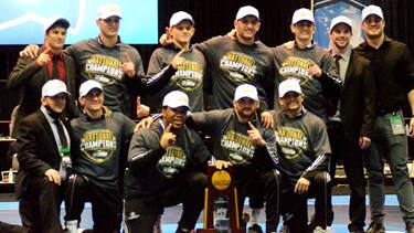 The St. Cloud State wrestling team poses with their national champion hats, shirts and trophy after winning the 2021 Div. II Nationals.