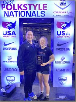 Shelby Moore of Washington receives the 16U Outstanding Wrestler Award at Girls Folkstyle Nationals