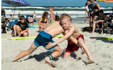 Two young boys wrestling at the 2021 U.S. Beach Nationals in Jacksonville, Fla.