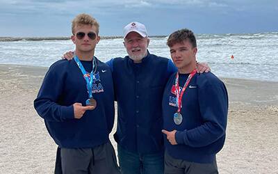 Dan Russell (center) with the Michaelson brothers at the 2022 Beach World Championships