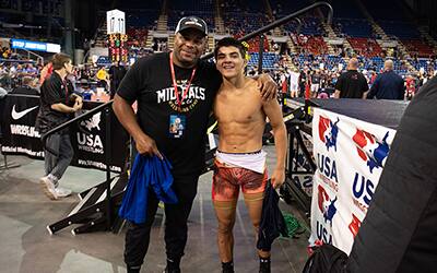 Daniel Cormier poses with a wrestler