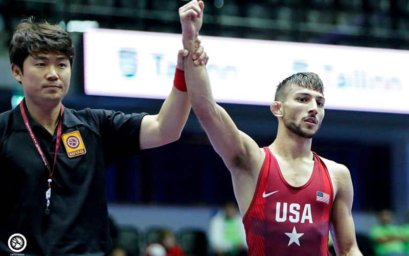 Vitali Arujau (USA) has his arm raised in victory