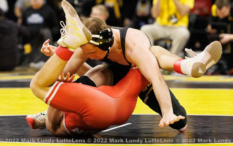 Spencer Lee (Iowa) works for the pin against Nebraska.