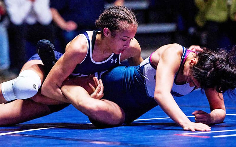 Action image of Menlo women's wrestler with an ankle lace