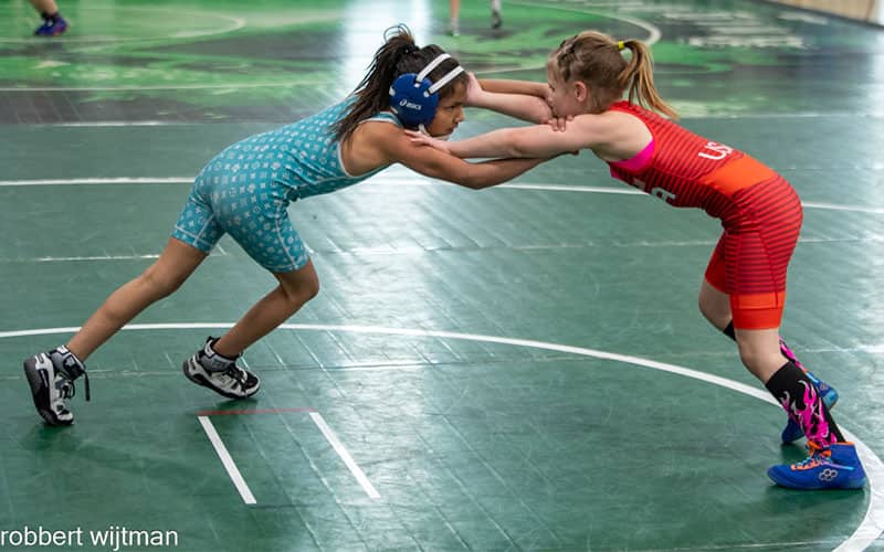 Two young girls tie up at the 2023 USMC Women's Nationals in Spokane