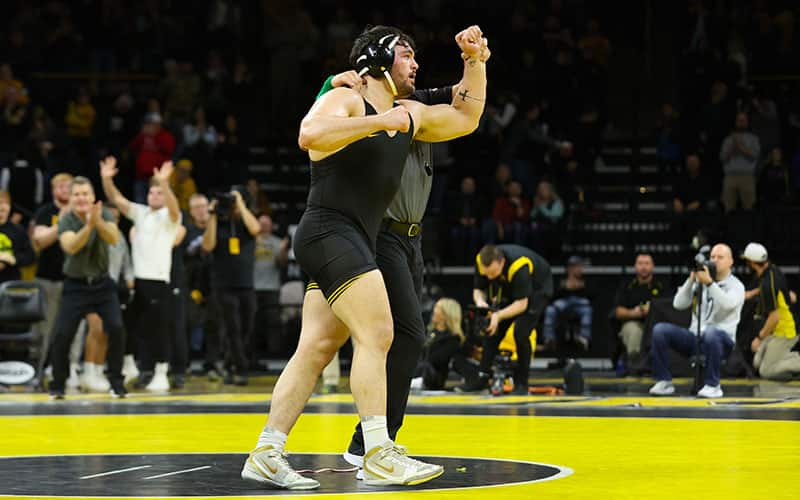 Tony Cassioppi (Iowa) has his arm raised in victory.