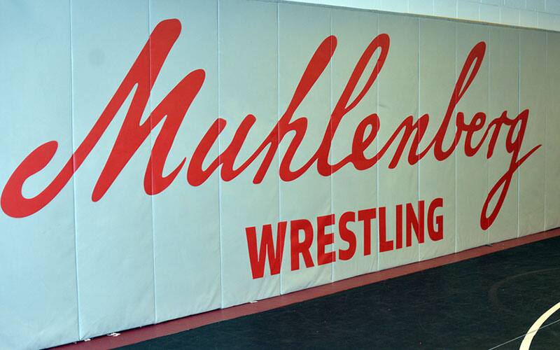 Muhlenberg logo on Wrestling Room wall mat